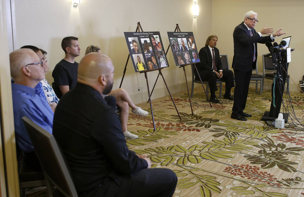 Attorney Mark P. Robinson, right, representing shooting victims and family members who lost loved ones in the Oct. 1, 2017, Las Vegas shooting, talks about MGM's decision, at a news conference in ...