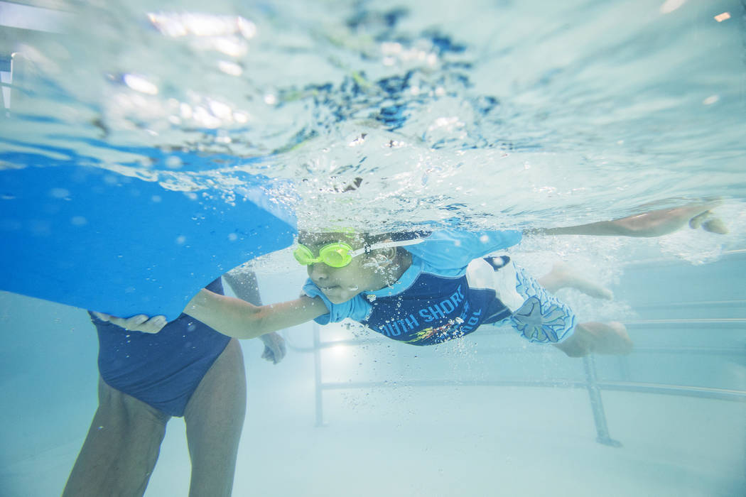 Justin Jachai, 7, practices his stroke during swim class at the Hollywood Aquatic Center on Monday, July 23, 2018, in Las Vegas. Benjamin Hager Las Vegas Review-Journal @benjaminhphoto