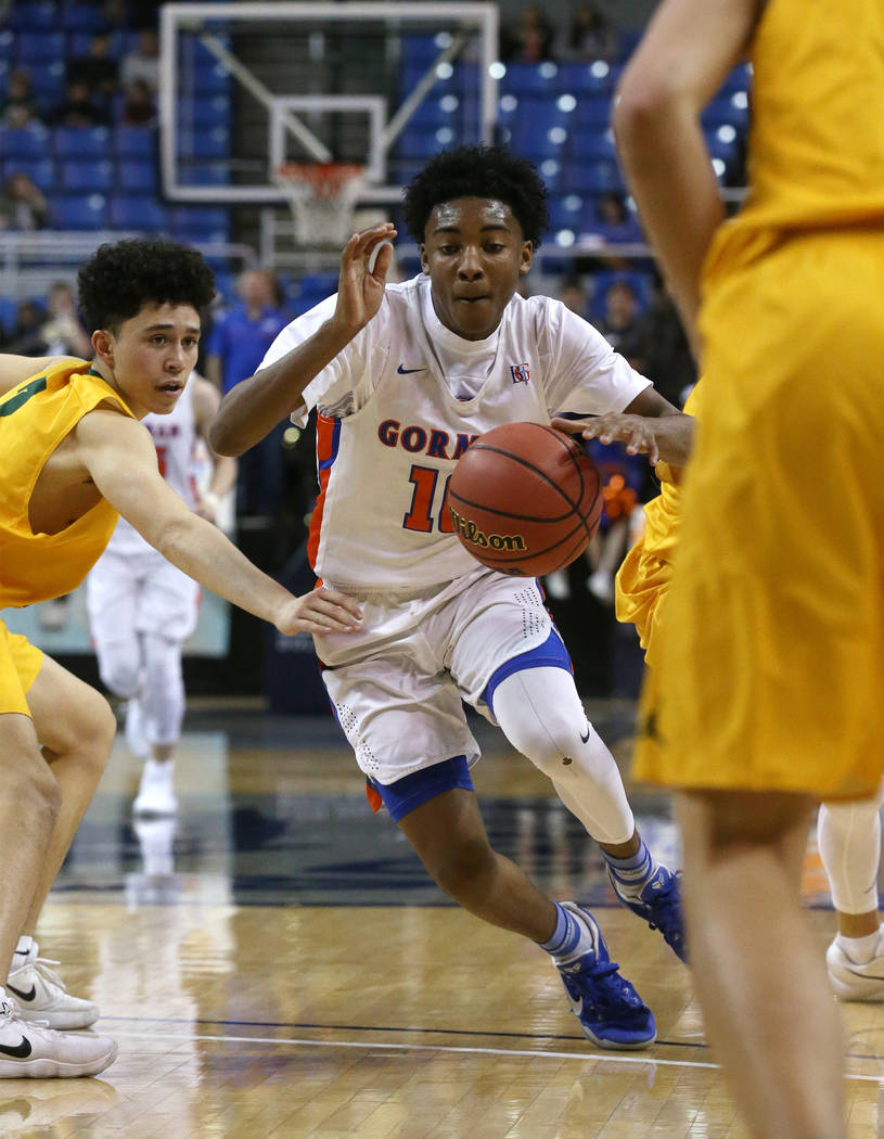 Bishop Gorman's Zaon Collins drives past a Bishop Manogue defender during the 4A NIAA state basketball championship game in Reno, Nev., on Friday, Feb. 23, 2018. Gorman won 62-41. Cathleen Allison ...