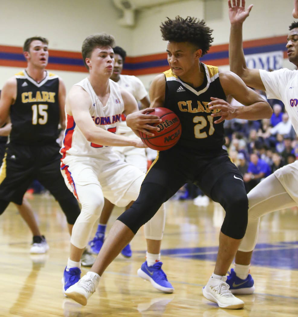 Clark's Jalen Hill (21) drives against Bishop Gorman's Chance Michels (25) during a basketball game at Bishop Gorman High School in Las Vegas on Friday, Feb. 9, 2018. Chase Stevens Las Vegas Revie ...