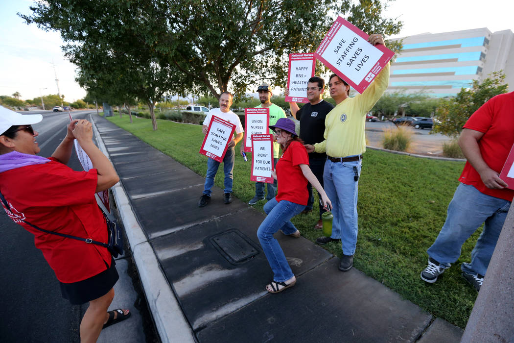 Toni Stockman, left, takes a photo of nurses and supporters affiliated with the Nevada chapter of the national Nurses Organizing Committee prepare to protest outside MountainView Hospital in Las V ...