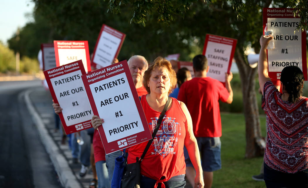Nurses and supporters affiliated with the Nevada chapter of the national Nurses Organizing Committee, including Dolly Covert, front, protest outside MountainView Hospital in Las Vegas Tuesday, Jul ...