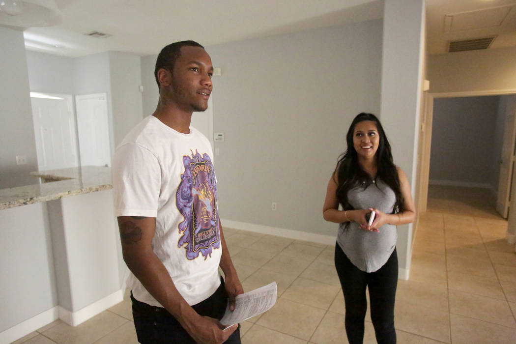 After a quick walkthrough, Darrius Mathis, left, and Kayte Fernandez discuss the details of a rental home with their real estate in Summerlin on Friday, July 20, 2018. Michael Quine Las Vegas Revi ...