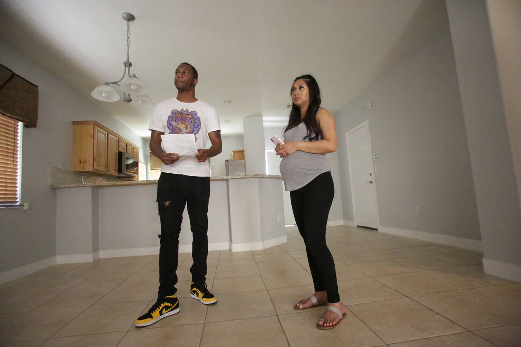 After a quick walkthrough, Darrius Mathis, left, and Kayte Fernandez listen to the details for a rental home in Summerlin on Friday, July 20, 2018. Michael Quine Las Vegas Review-Journal @Vegas88s