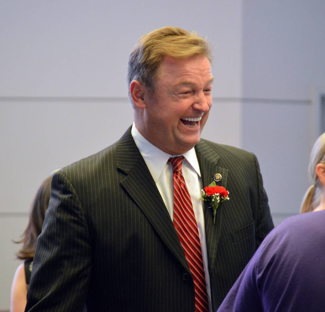 U.S. Sen. Dean Heller jokes with a fellow attendee at the Memorial Day ceremony on Monday at the Southern Nevada Veterans Memorial Cemetery in Boulder City. (Celia Shortt Goodyear/Boulder City Review)