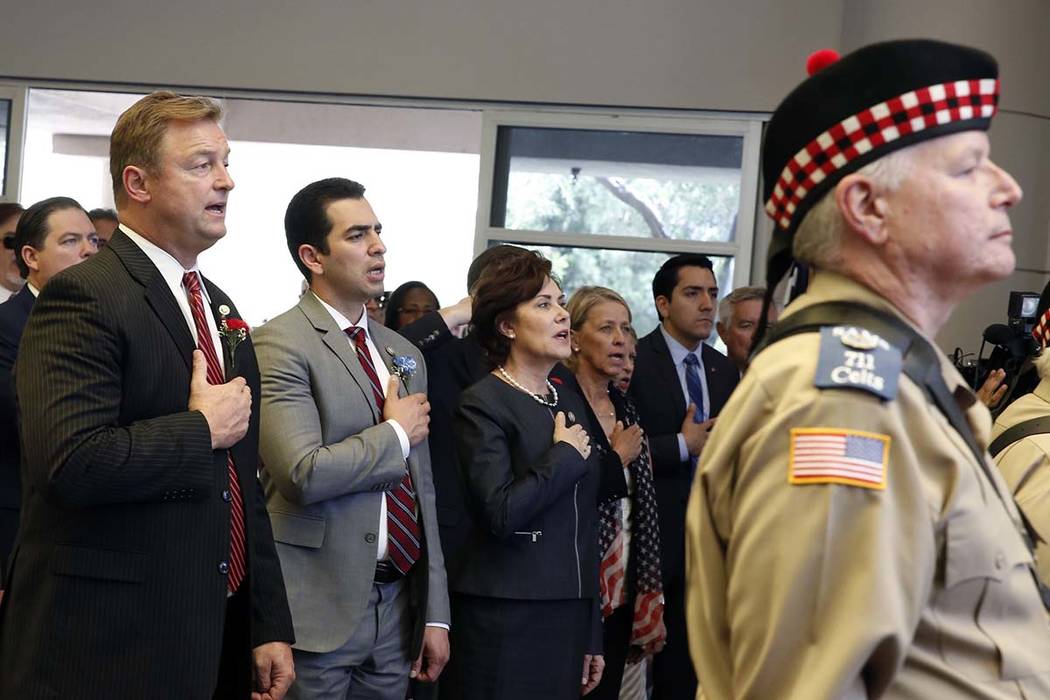 Sen. Dean Heller, R-Nev, left, U.S. Rep. Ruben Kihuen, D-Nev, and U.S. Rep. Jacky Rosen, D-Nev, right, attend the Memorial Day event at the Southern Nevada Veterans Memorial Cemetery on Monday, Ma ...