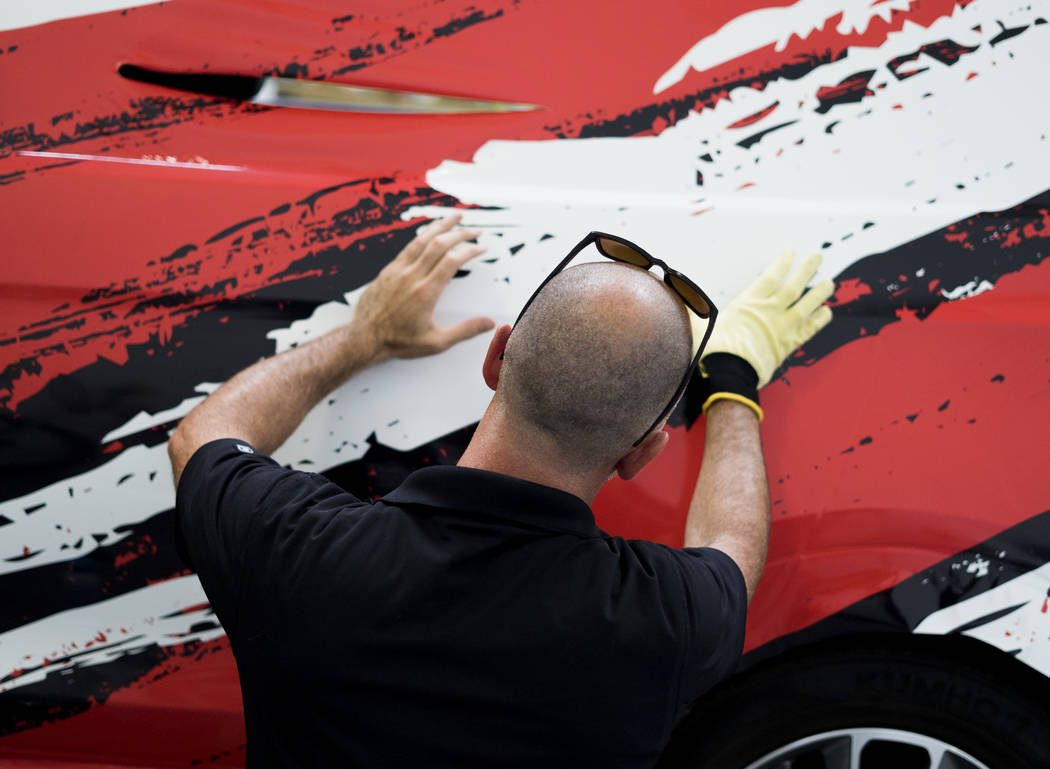 Henderson company's niche: Wrapping vehicles in ads, Henderson