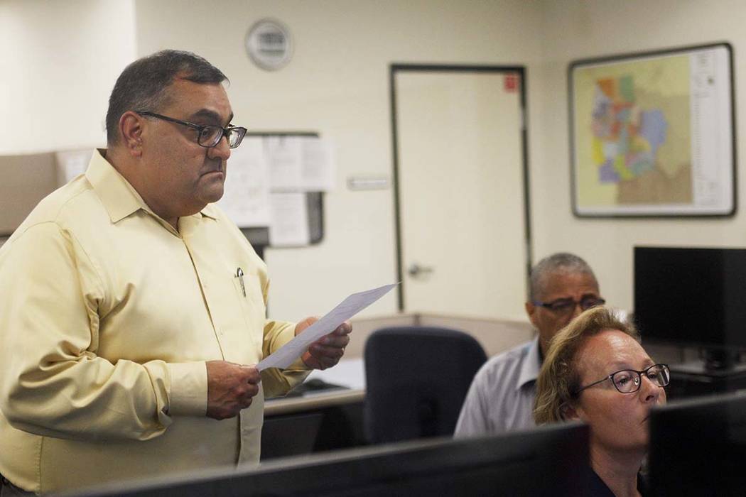 Joe Gloria, the county registrar of voters, looks over Program Supervisor Kelly Fisher's shoulders in the tabulation room after initial results come in for the redo election for the Republican pri ...