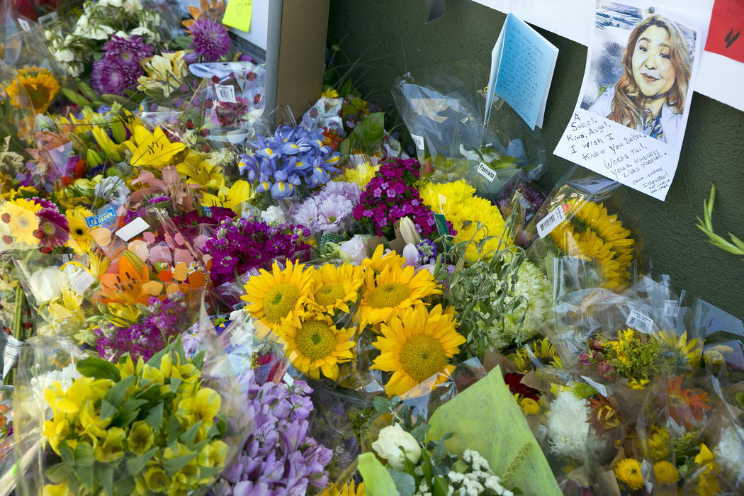A note with the likeness of Trader Joe's employee Melyda Corado is surrounded by flowers, candles and support notes growing on the sidewalk outside the Silver Lake Trader Joe's store in Los Angele ...