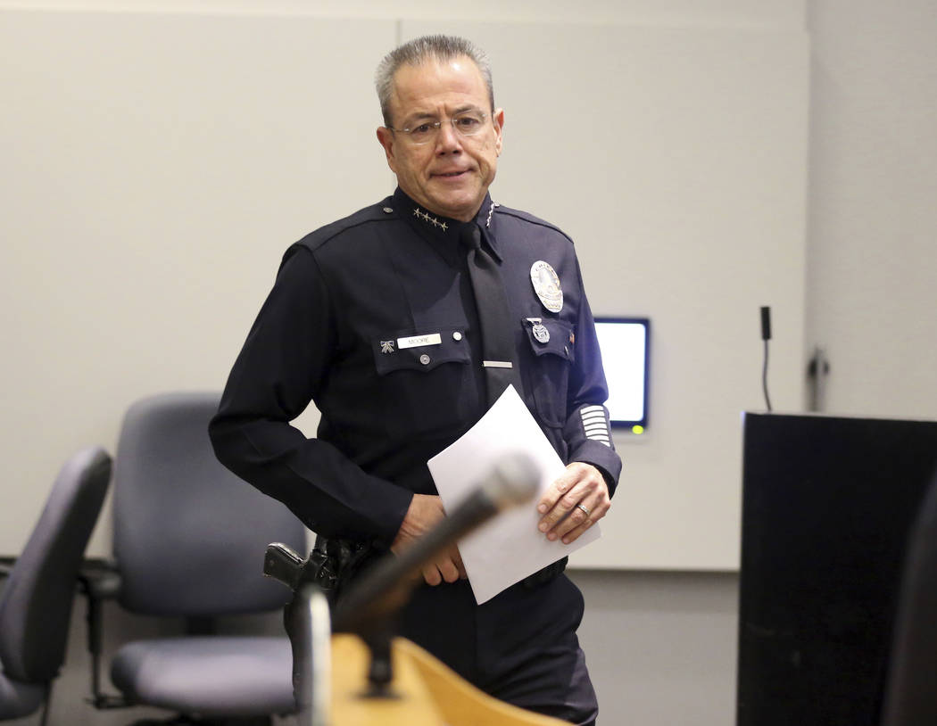 Los Angeles Police Chief Michel Moore approaches the podium at a news conference at police headquarters Tuesday, July 24, 2018, in Los Angeles, where he announced that a store worker killed in a g ...