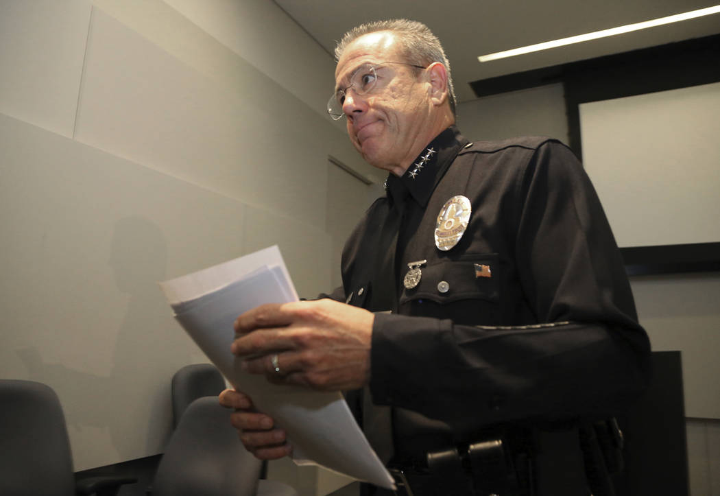 Los Angeles Police Chief Michel Moore leaves a news conference at police headquarters Tuesday, July 24, 2018, in Los Angeles, where he announced that a store worker killed in a gun battle before a ...
