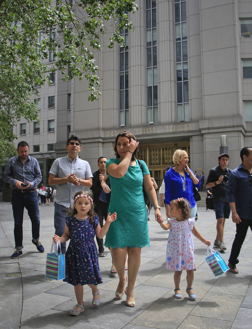 Pablo Villavicencio's wife Sandra Chica, center, and their two daughters, leave federal court after a hearing calling for his release, Tuesday July 24, 2018, in New York. Villavicencio, a pizza de ...