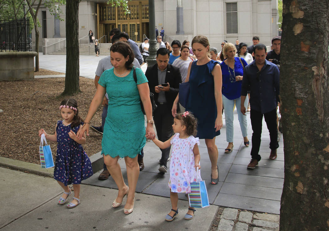 Pablo Villavicencio's wife Sandra Chica, center, leave federal court with their two daughters, after a hearing on his release, Tuesday July 24, 2018, in New York. Villavicencio, a pizza delivery m ...