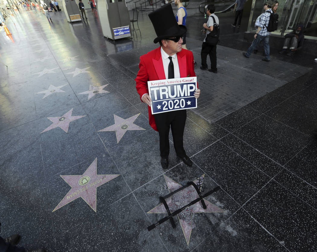 Gregg Donovan stands near the vandalized star of Donald Trump on the Hollywood Walk of Fame Wednesday, July 25, 2018. Authorities said a pickax was used in the vandalism.(Reed Saxon/AP)