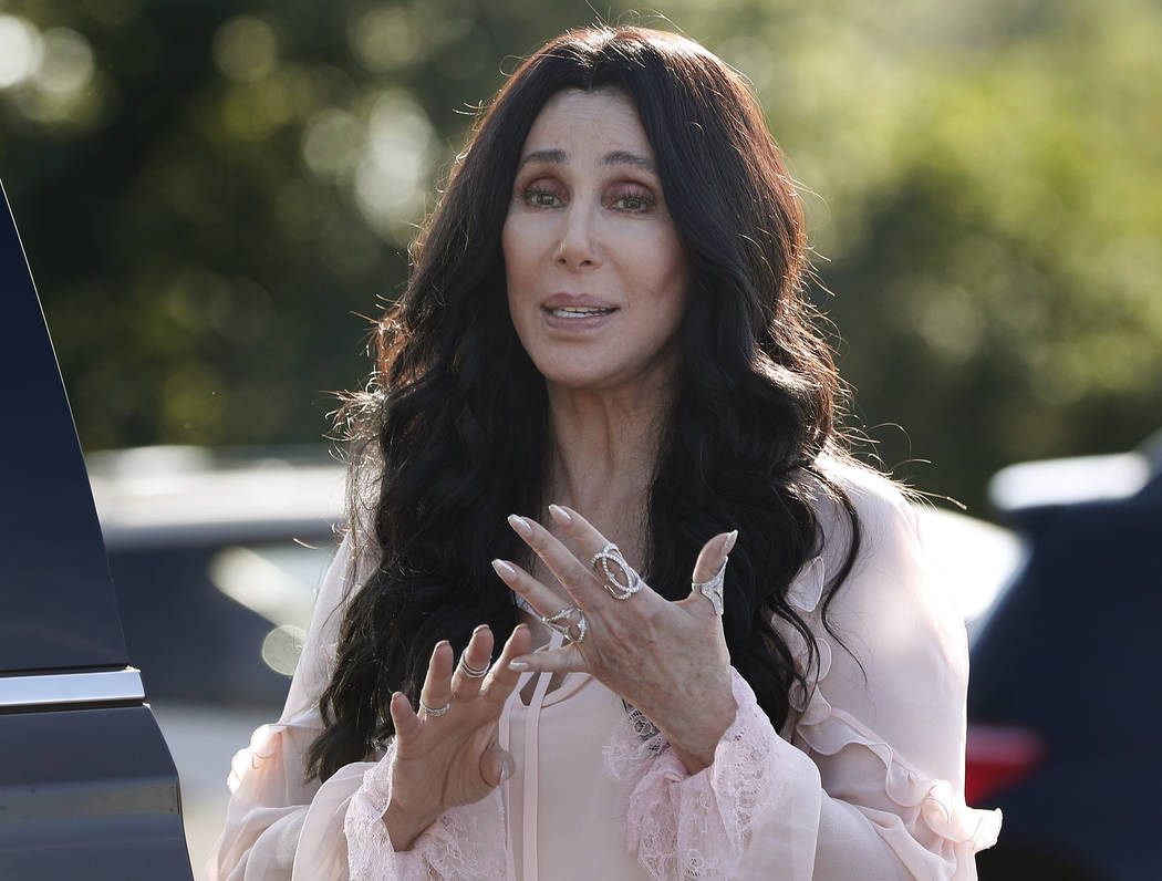 Singer and actress Cher stops to talk to media as she leaves a fundraiser for Hillary Clinton at the Pilgrim Monument and Provincetown Museum in Provincetown, Massachusetts, Aug. 21, 2016. (Caroly ...