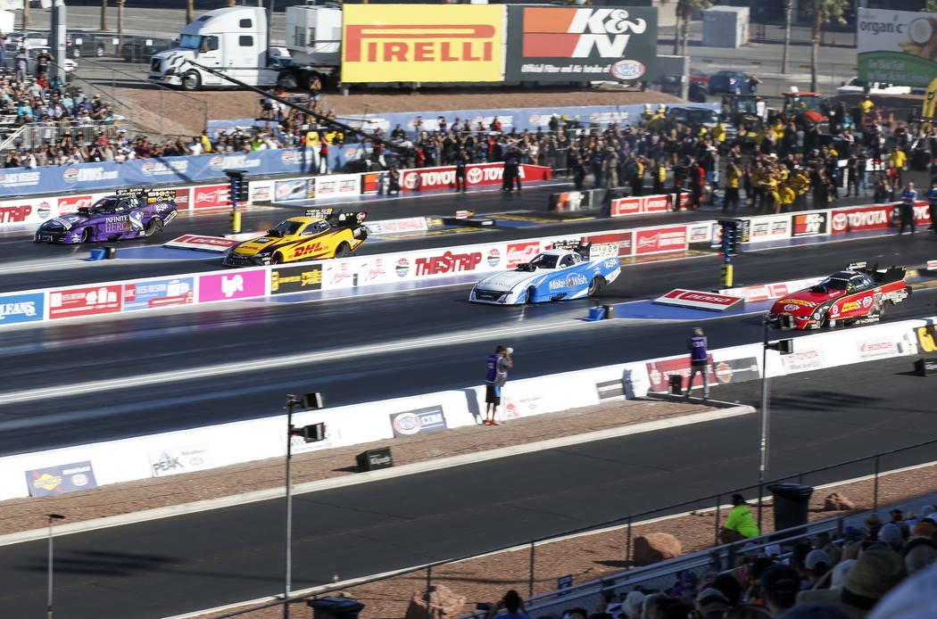 Funny Car drivers, from left to right, J.R. Todd, Tommy Johnson Jr., Jack Beckman, and Courtney Force, prepare compete in the final elimination race of the DENSO Spark Plug NHRA Four-Wide National ...