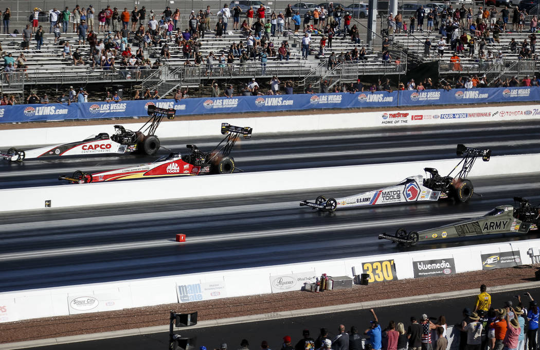 Top Fuel drivers, from top to bottom, Steve Torrence, Doug Kalitta, Antron Brown and Tony Schumacher compete in the final elimination race of the DENSO Spark Plug NHRA Four-Wide Nationals at The S ...