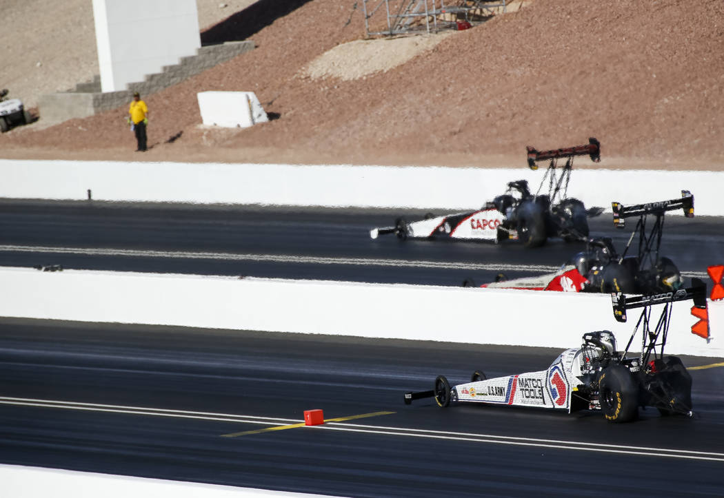 Top Fuel drivers, from top to bottom, Steve Torrence, Doug Kalitta, Antron Brown and Tony Schumacher (not shown) compete in the final elimination race of the DENSO Spark Plug NHRA Four-Wide Nation ...