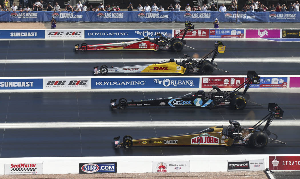 Top Fuel drivers, from above, Doug Kalitta, Richie Crampton, Scott Palmer and Leah Pritchett compete on the new four-wide track during the first day of qualifying for the DENSO Spark Plugs NHRA Na ...