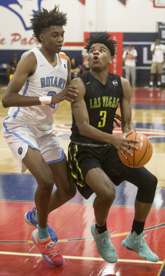 Las Vegas Prospects point guard Jaden Hardy (3) drives past Seattle Rotary forward Jaden McDaniels (2) in the first half during the Made Hoops Summer Showcase on Wednesday, July 25, 2018, at Liber ...