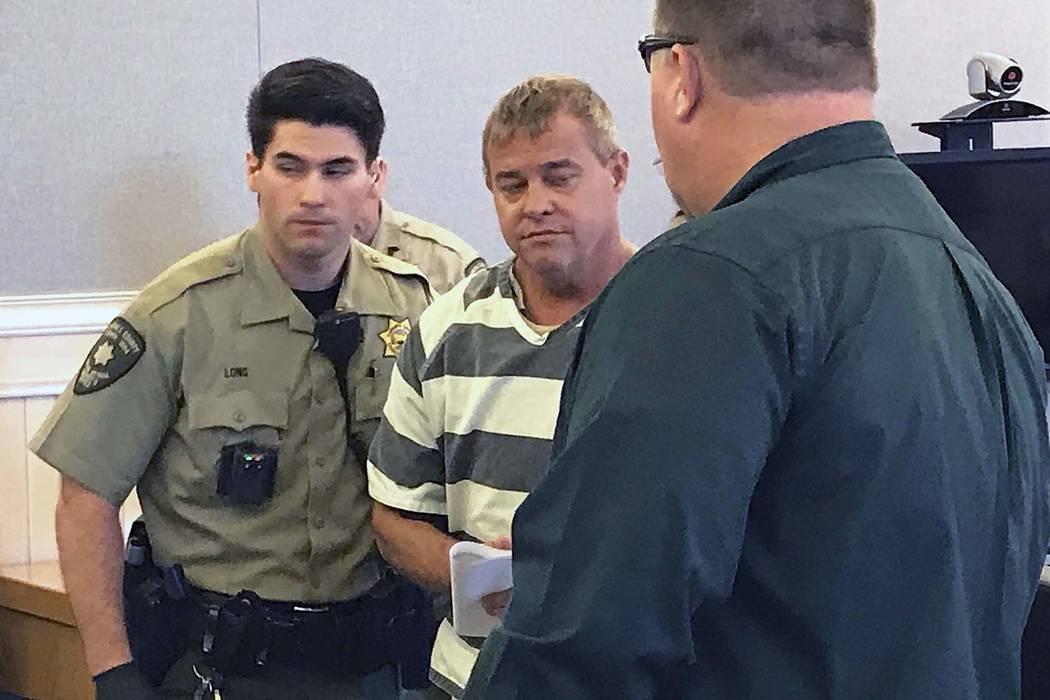 Churchill County sheriff's deputies lead John K. O'Connor from the courtroom, Wednesday, July 25, 2018 in Fallon. O'Connor is accused of fatally shooting a fellow member of his congregation during ...