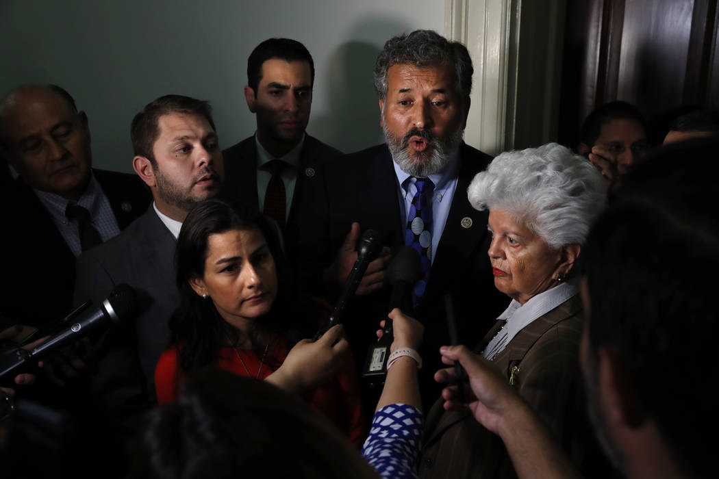 Rep. Juan Vargas, D-Calif., center, speaks about the Congressional Hispanic Caucus' meeting with Homeland Security Secretary Kirstjen Nielsen, Wednesday, July 25, 2018, on Capitol Hill in Washingt ...