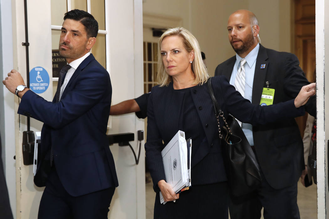 Homeland Security Secretary Kirstjen Nielsen, center, arrives for a closed doors meeting with the Congressional Hispanic Caucus, Wednesday, July 25, 2018, on Capitol Hill in Washington. (AP Photo/ ...