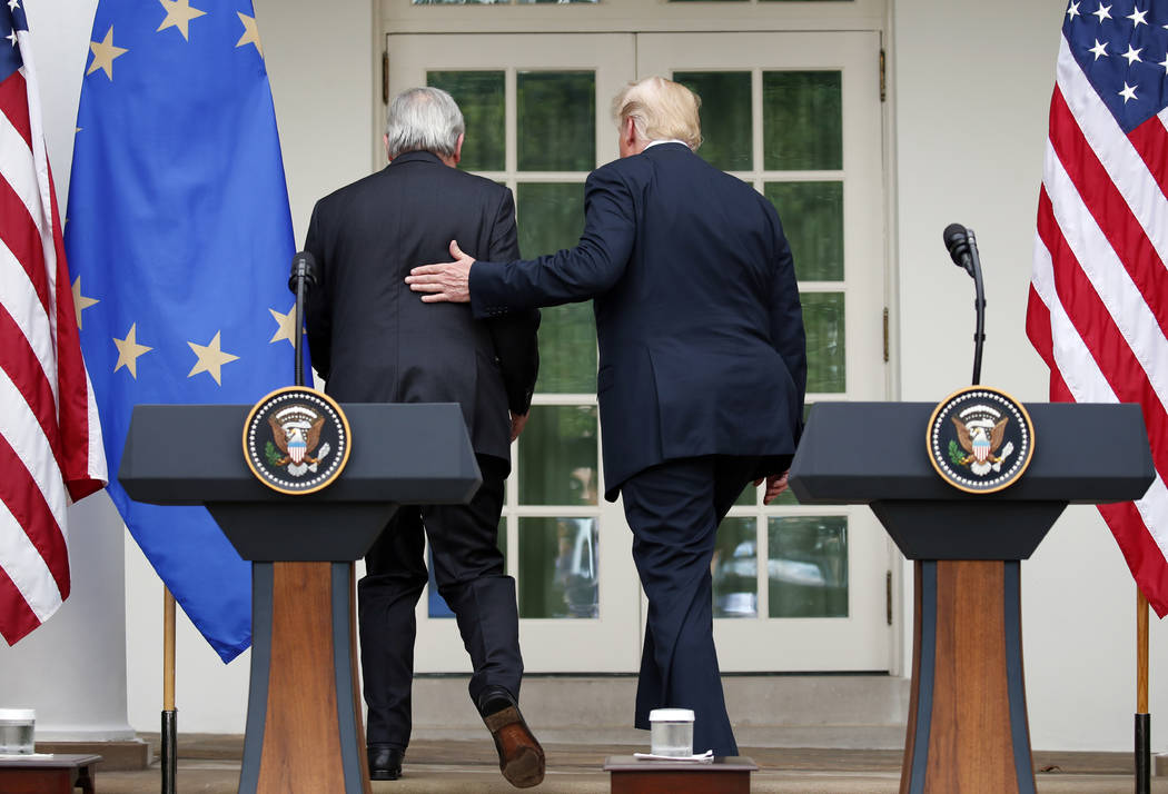 President Donald Trump, right, and European Commission president Jean-Claude Juncker walk from the podiums after speaking in the Rose Garden of the White House, Wednesday, July 25, 2018, in Washin ...