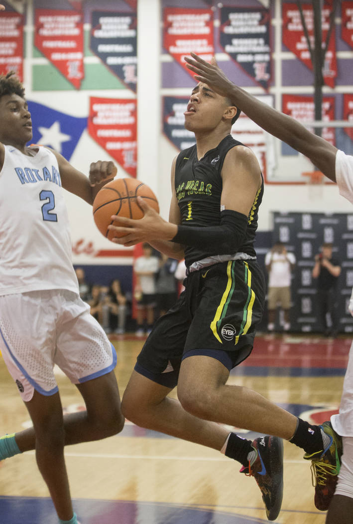 Las Vegas Prospects guard Julian Strawther (1) drives past Seattle Rotary forward Jaden McDaniels (2) in the first half during the Made Hoops Summer Showcase on Wednesday, July 25, 2018, at Libert ...
