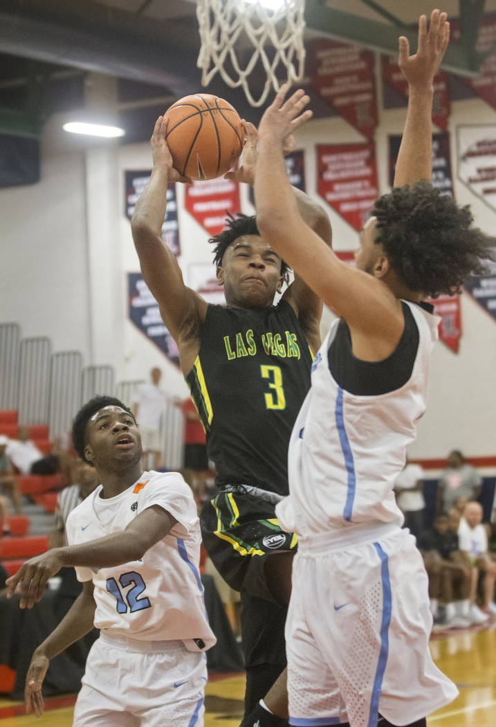 Las Vegas Prospects point guard Jaden Hardy (3) drives past Seattle Rotary defenders Jaden McDaniels (2) and Jishai Miller (12) in the first half during the Made Hoops Summer Showcase on Wednesday ...