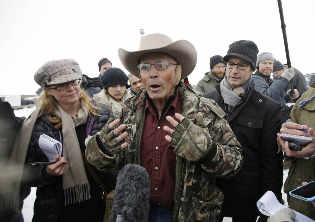 In this Jan. 5, 2016 file photo, Robert "LaVoy" Finicum, center, a rancher from Arizona, talks to reporters at the Malheur National Wildlife Refuge near Burns, Ore. (AP Photo/Rick Bowmer, File)