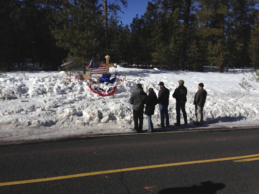 In this Jan. 21, 2016, file photo, mourners gather at roadside memorial for rancher LaVoy Finicum near Burns, Ore. (AP Photo/Nick K. Geranios, File)