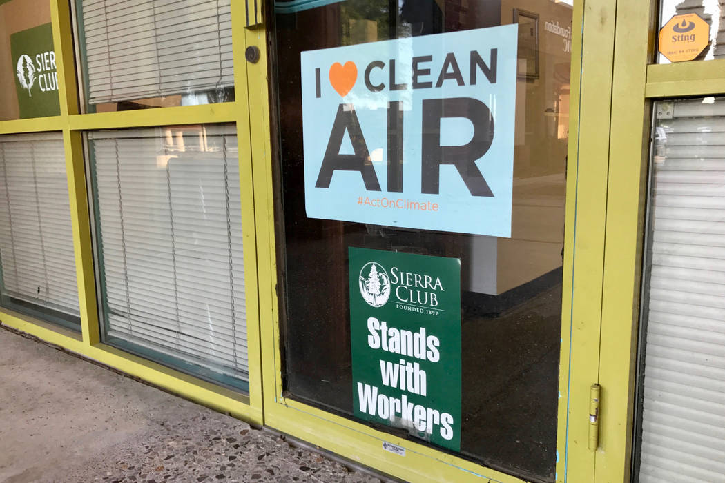 Advocacy signs hang in the window of the Sierra Club Southern Nevada Group's new offices on Meadows Lane on Aug. 24, 2017.(Madelyn Reese/View) @MadelynGReese