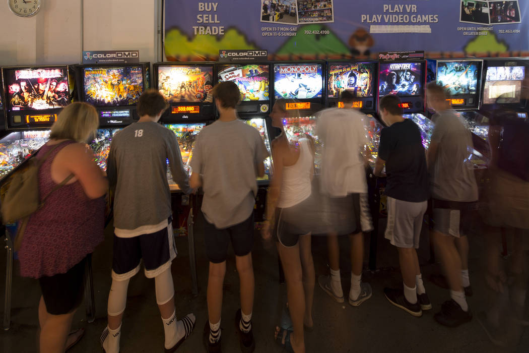 Patrons crowd a row of pinball machines at the Pinball Hall of Fame located at 1610 E. Tropicana Avenue in Las Vegas on Saturday, July 28, 2018. Richard Brian Las Vegas Review-Journal @vegasphotograph