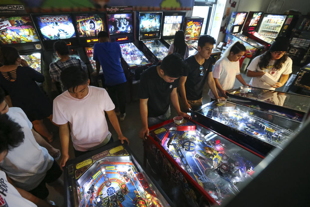 Patrons crowd a row of pinball machines at the Pinball Hall of Fame located at 1610 E. Tropicana Avenue in Las Vegas on Saturday, July 28, 2018. Richard Brian Las Vegas Review-Journal @vegasphotograph