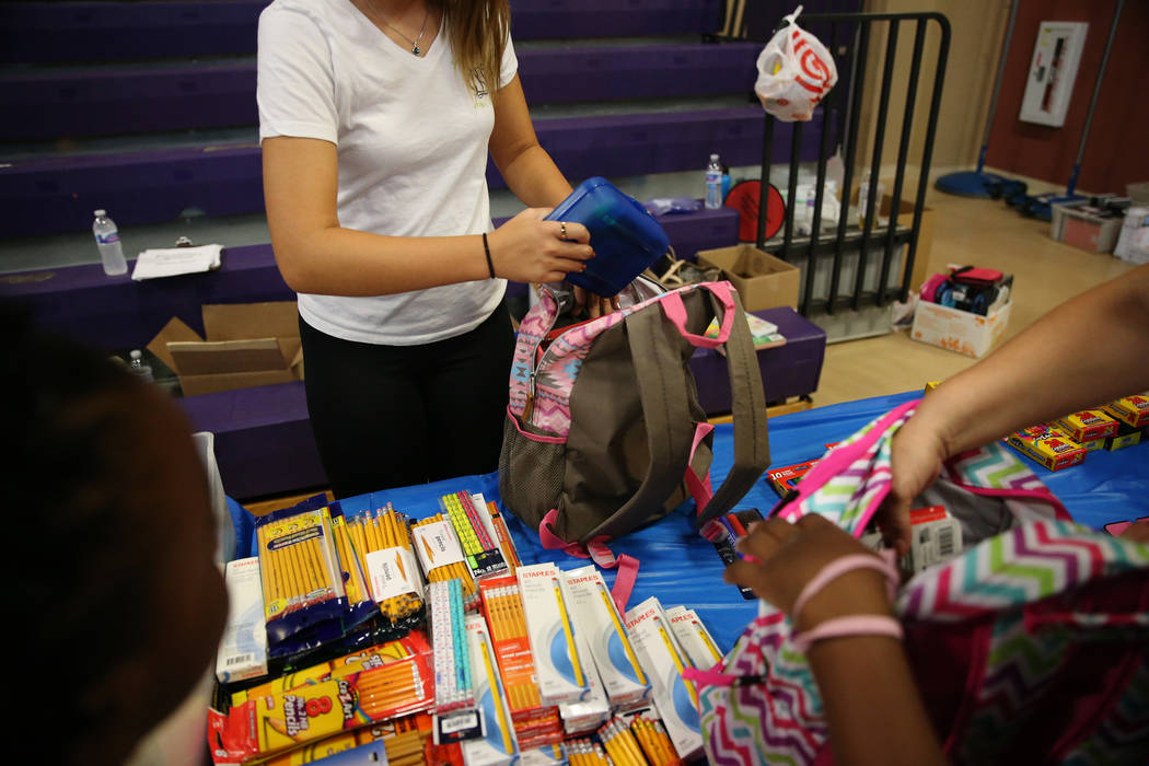 Foster children receive school supplies including a backpack during an event sponsored by Foster Change at the Clark County Family Services Department in Las Vegas, Thursday, July 26, 2018. Erik V ...