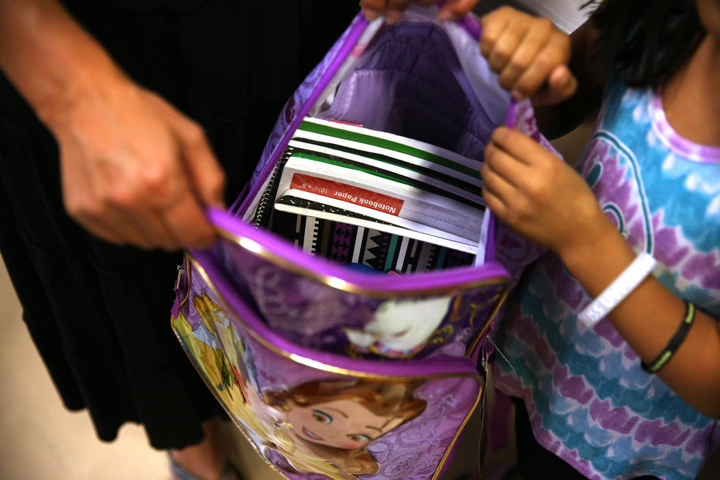 A foster child receives school supplies including a backpack during an event sponsored by Foster Change at the Clark County Family Services Department in Las Vegas, Thursday, July 26, 2018. Erik V ...