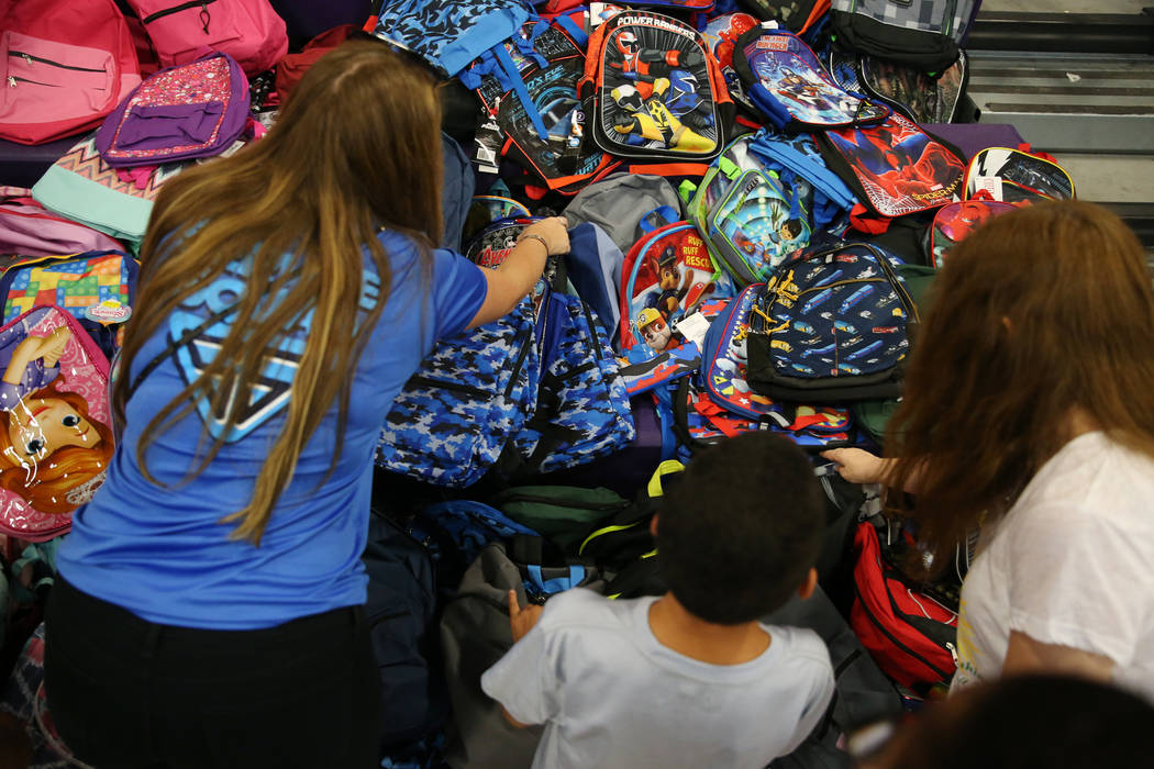 Foster children receive school supplies including backpacks during an event sponsored by Foster Change at the Clark County Family Services Department in Las Vegas, Thursday, July 26, 2018. Erik Ve ...