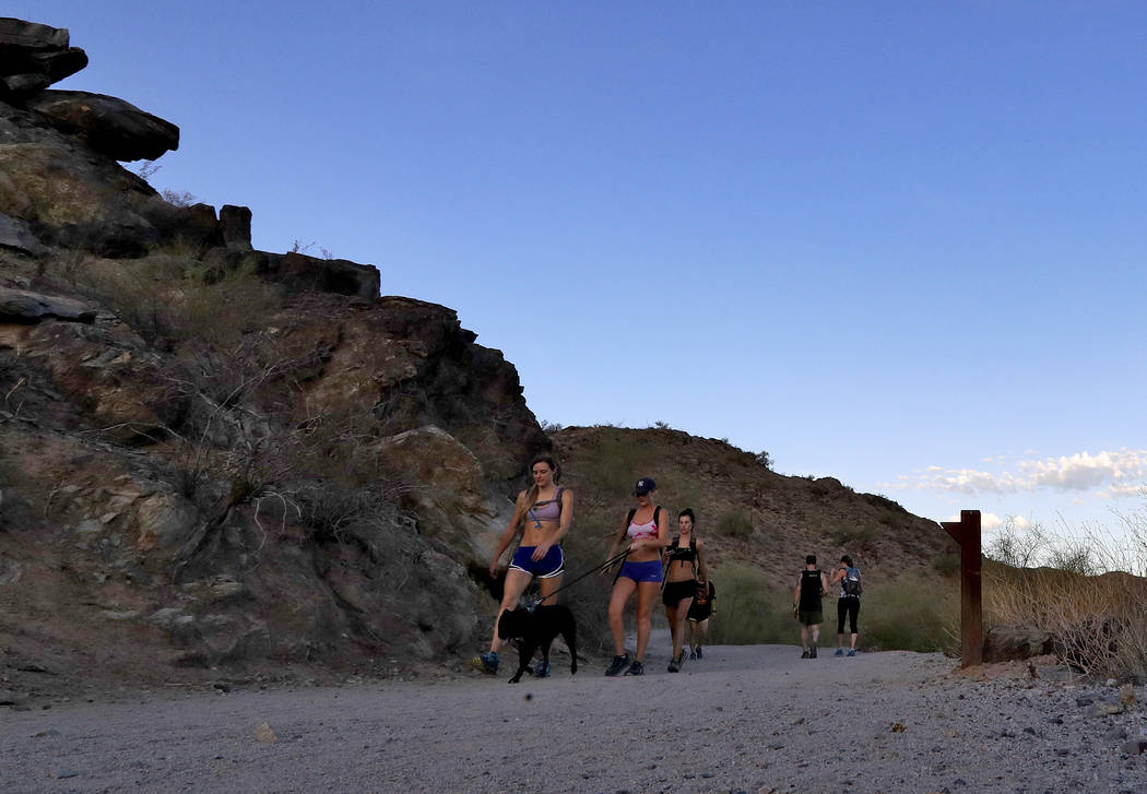 In this Tuesday, July 24, 2018 photo, hikers beat the heat on the trails at first light in Phoenix as temperatures exceed 95 degrees before sunrise. (AP Photo/Matt York)