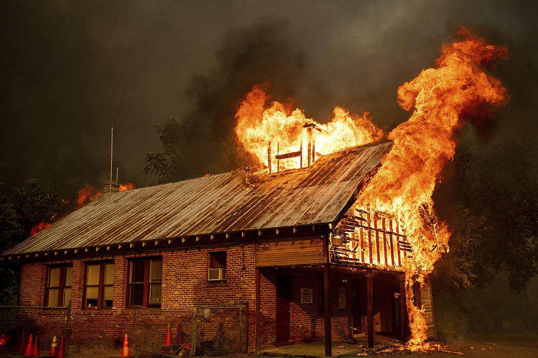 An historic schoolhouse burns as the Carr Fire tears through Shasta, Calif., Thursday, July 26, 2018. (AP Photo/Noah Berger)