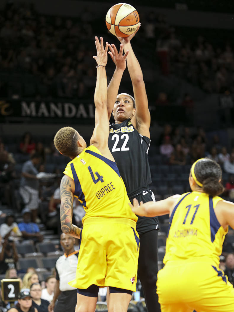 Las Vegas Aces center A'ja Wilson (22) shoots over Indiana Fever forward Candice Dupree (4) during the first half of a WNBA basketball game at the Mandalay Bay Events Center in Las Vegas on Sunday ...