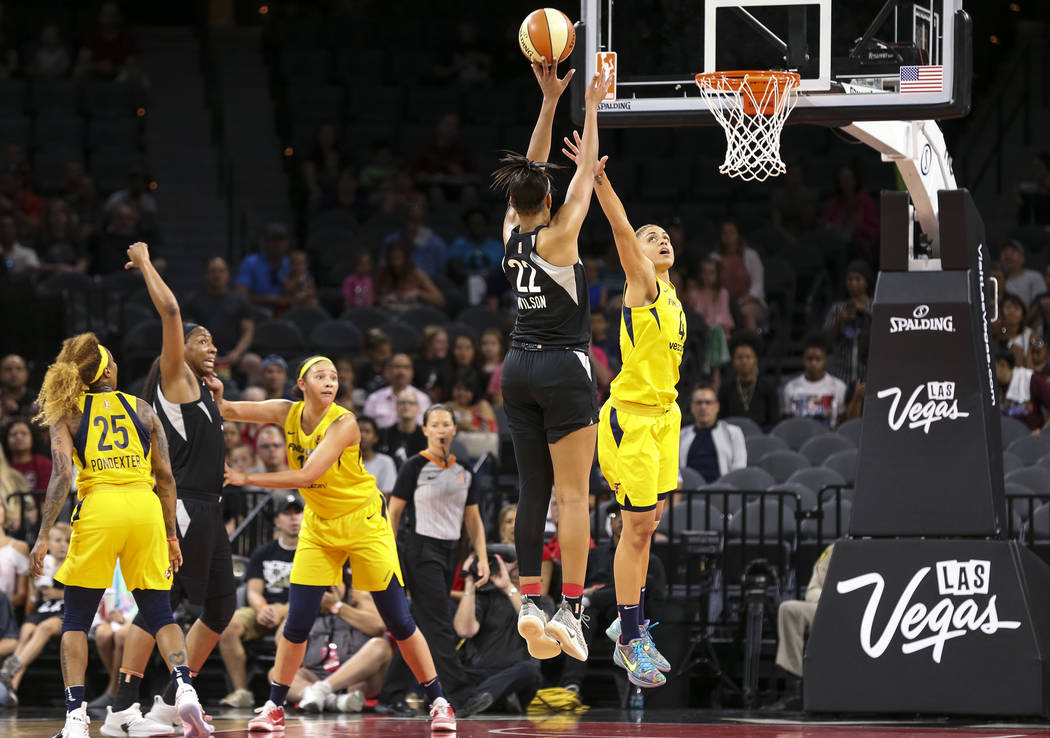 Las Vegas Aces center A'ja Wilson (22) takes a shot over Indiana Fever forward Candice Dupree (4) during the first half of a WNBA basketball game at the Mandalay Bay Events Center in Las Vegas on ...