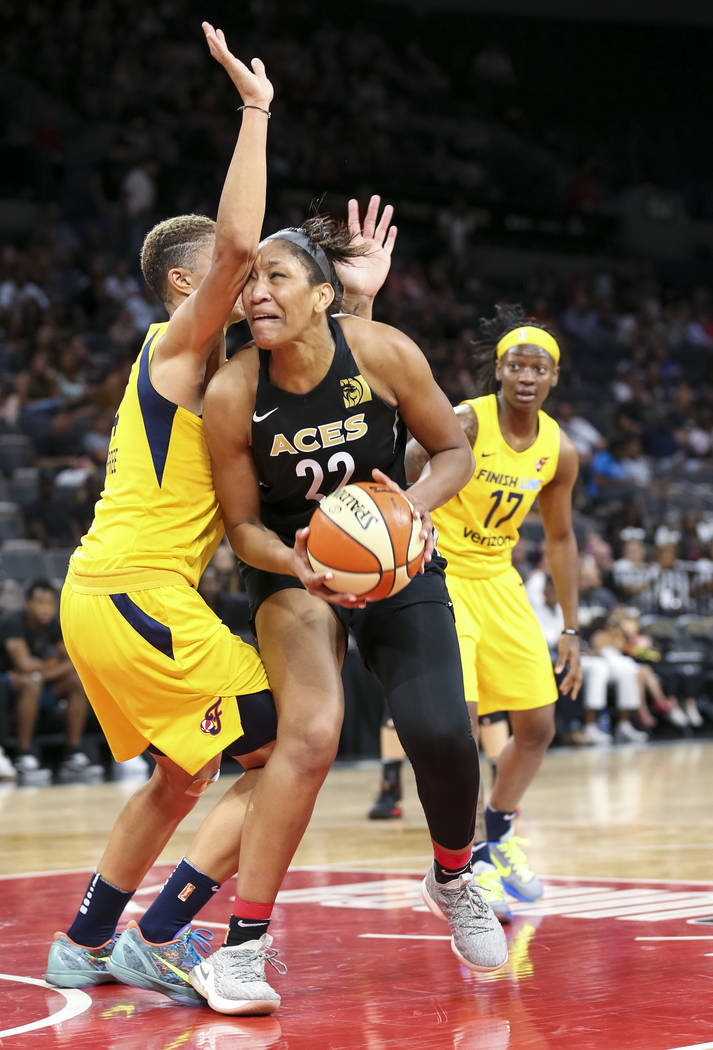 Las Vegas Aces center A'ja Wilson (22) drives the ball against Indiana Fever forward Candice Dupree (4) during the first half of a WNBA basketball game at the Mandalay Bay Events Center in Las Veg ...