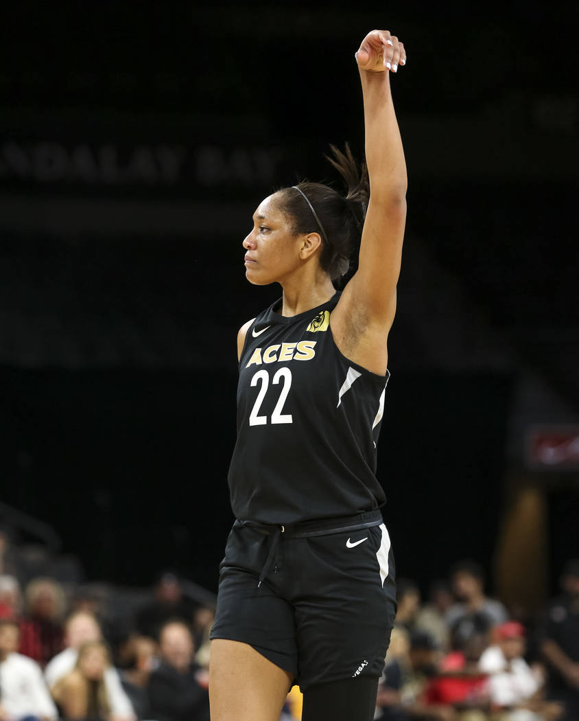 Las Vegas Aces center A'ja Wilson (22) reacts after getting fouled by Los Angeles Sparks forward Candace Parker (3) during the second half of a WNBA basketball game at the Mandalay Bay Events Cent ...