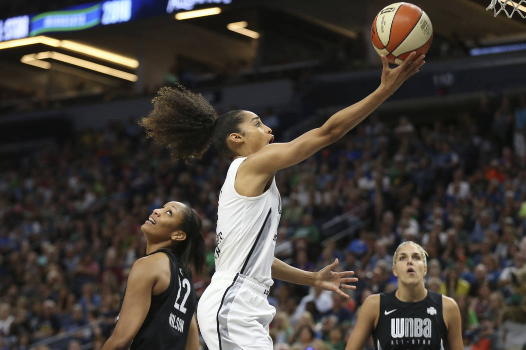 Team Candace Parker's Skylar Diggins-Smith, center, goes to the basket against Team Delle Donne's A'ja Wilson (22) in the first half of the WNBA All-Star basketball game Saturday, July 28, 2018 in ...