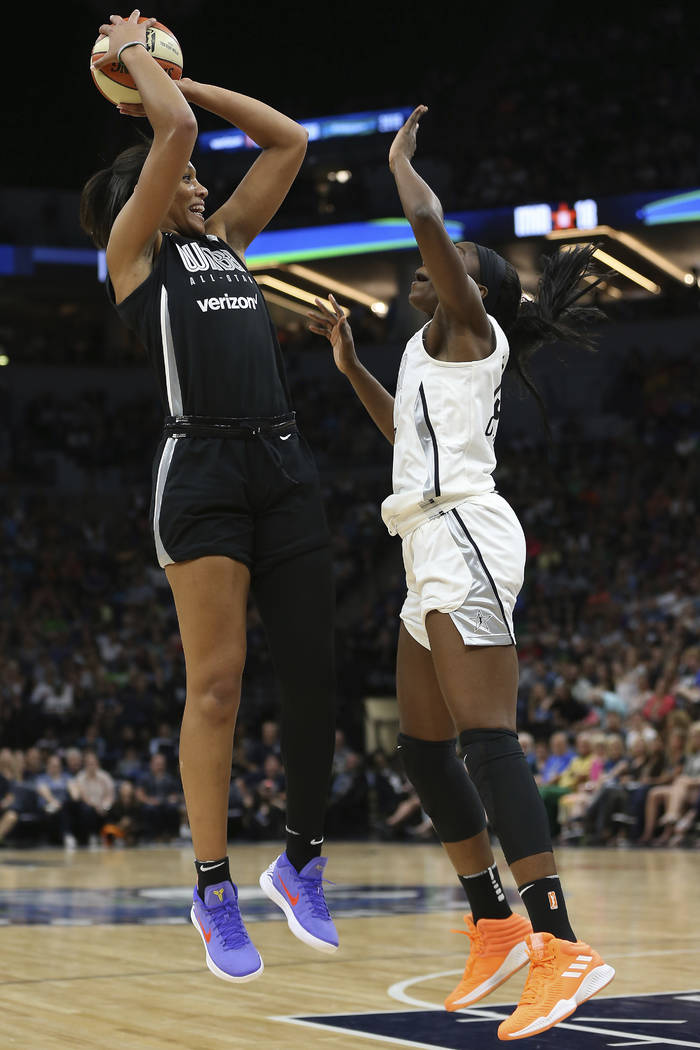 Team Delle Donne's A'ja Wilson, left, shoots the ball against the Team Candace Parker's Chiney Ogwumike, right, in the first half of the WNBA All-Star basketball game Saturday, July 28, 2018 in Mi ...