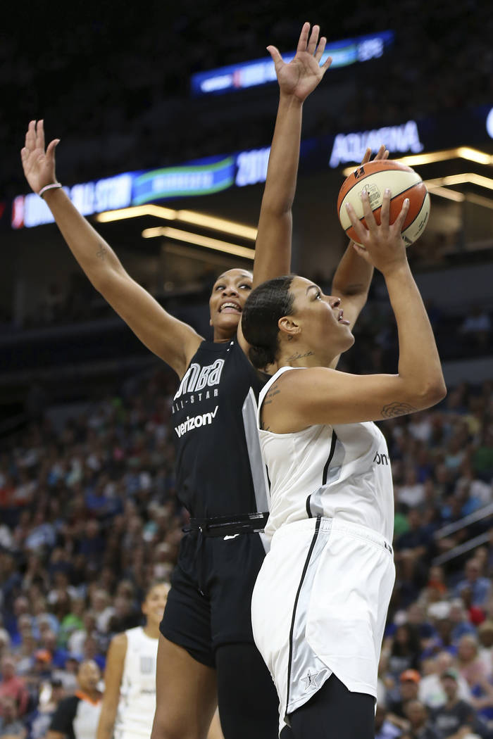 Team Candace Parker's Liz Cambage, right, shoots the ball against Team Delle Donne's A'ja Wilson, left, in the first half of the WNBA All-Star basketball game Saturday, July 28, 2018 in Minneapoli ...