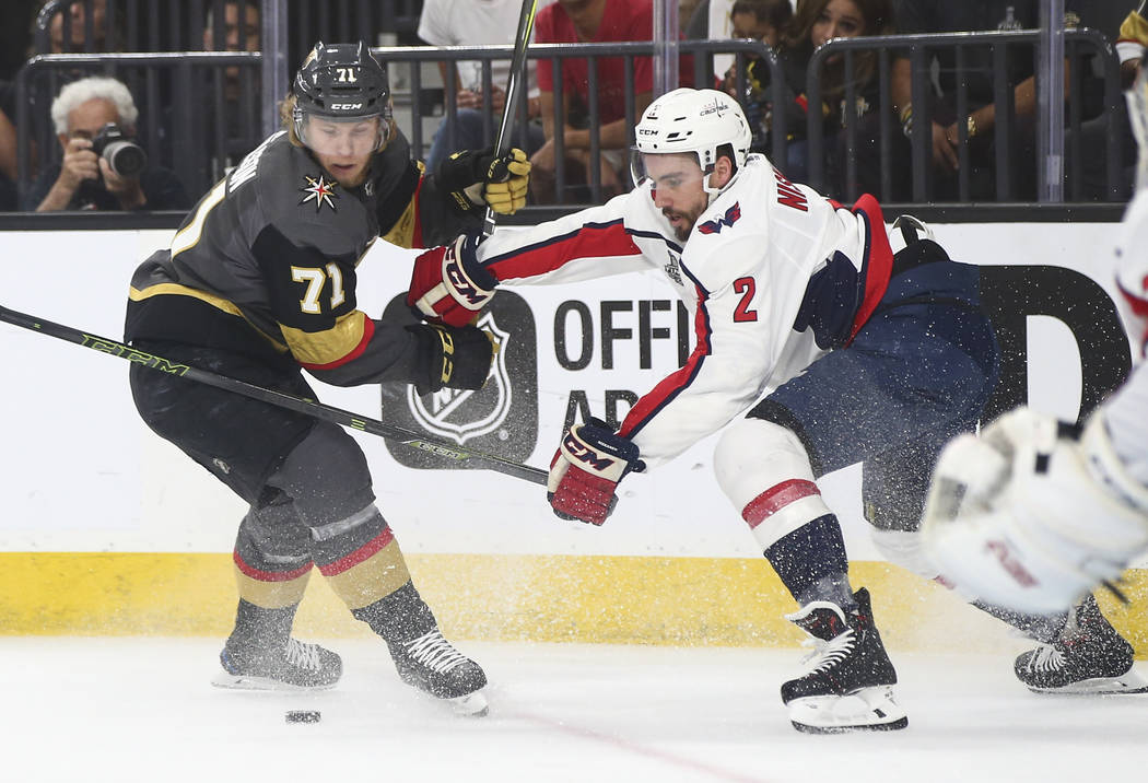 Golden Knights center William Karlsson (71) and Washington Capitals defenseman Matt Niskanen (2) battle for the puck during the first period of Game 2 of the NHL hockey Stanley Cup Final at the T- ...