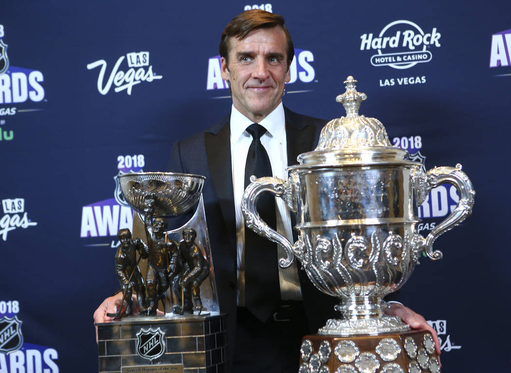 George McPhee, general manager of th Golden Knights, poses with the General Manager of the Year award and the Clarence S. Campbell Bowl during the NHL Awards at the Hard Rock Hotel in Las Vegas on ...