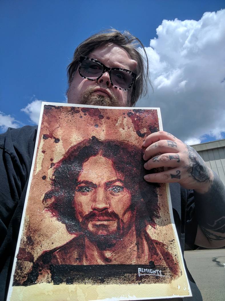 Artist Ryan Almighty shows a painting of Charles Manson, with Manson's ashes used for the eyes, before he shipped the piece to Zak Bagans' Haunted Museum on Saturday, July 28, 2018. (Zak Bagans' H ...